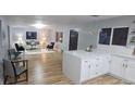Open-concept living area featuring new flooring and lots of natural light at 409 N Finch Ave, Lafayette, CO 80026