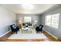 Cozy living room with bright windows, plush seating, and decorative wall art at 409 N Finch Ave, Lafayette, CO 80026