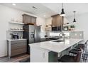 Modern kitchen featuring stainless steel appliances, white countertops, and stylish pendant lighting at 10224 Worchester St, Commerce City, CO 80022