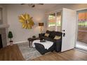 Comfortable living room with a dark sofa, decor, and access to the outdoors at 6845 S Webster St # E, Littleton, CO 80128