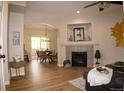 Inviting living room featuring a cozy fireplace, dining area, and natural light at 6845 S Webster St # E, Littleton, CO 80128