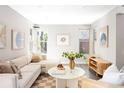 Bright, neutral living room with large windows, stylish decor, and comfortable seating at 3025 Forest St, Denver, CO 80207