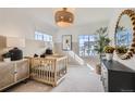 Bright Bedroom featuring modern decor, neutral tones, and natural light streaming through the windows at 907 W Beverly St, Elizabeth, CO 80107