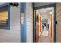 Inviting condo entryway featuring unit number, wreath, and wood flooring at 107 N Harris St # 102, Breckenridge, CO 80424