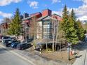 Condo exterior with trees, parking, sidewalk, and a red fire hydrant at 107 N Harris St # 102, Breckenridge, CO 80424