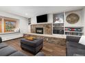 Cozy living room with stone fireplace, built-in shelves, and window seat at 107 N Harris St # 102, Breckenridge, CO 80424