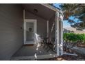 Cozy front porch with seating area, welcome sign, and neutral exterior, inviting guests into the home at 87 Macon Ct, Aurora, CO 80010