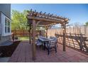 Backyard patio with an inviting pergola and dining set perfect for outdoor entertaining at 87 Macon Ct, Aurora, CO 80010