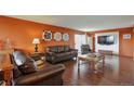 Comfortable living room with hardwood floors, warm paint color, and plenty of seating at 3131 E Alameda Ave # 704, Denver, CO 80209