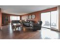 Cozy living room with hardwood floors, balcony access, and natural light at 3131 E Alameda Ave # 704, Denver, CO 80209