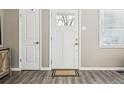 Clean entryway featuring a white door with glass panes, adjacent to another white door and a window at 2332 Hanover St, Aurora, CO 80010