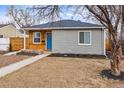 Quaint single story home with a mix of wood and grey siding, showcasing its unique charm at 2332 Hanover St, Aurora, CO 80010