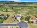 An aerial view showcases the home's location amid a beautiful, sprawling landscape at 3221 Autumn Sun Cir, Castle Rock, CO 80104