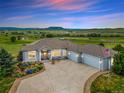 Beautiful single-story home with large driveway, three-car garage, and scenic views at 3221 Autumn Sun Cir, Castle Rock, CO 80104