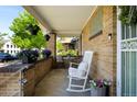 Cozy front porch with a rocking chair and view of the neighborhood, perfect for relaxing outdoors at 2026 S Lincoln St, Denver, CO 80210