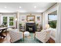 Bright living room featuring a fireplace, large windows, and stylish furnishings at 2026 S Lincoln St, Denver, CO 80210