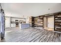 Open-concept living area featuring updated flooring and a stylish accent wall at 9605 Elk Mountain Cir, Littleton, CO 80125