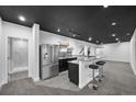 Finished basement featuring granite bar with stainless steel fridge at 1665 Diamond Head Dr, Castle Rock, CO 80104