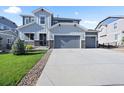 Stylish two-story home featuring a spacious three car garage and modern architectural details at 1665 Diamond Head Dr, Castle Rock, CO 80104
