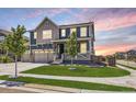 Beautiful two-story home with a manicured lawn, three-car garage, and lovely curb appeal at 10991 Xanadu St, Commerce City, CO 80022