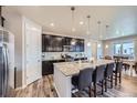 A well-equipped kitchen with a central island, bar stools, and ample cabinet space at 10991 Xanadu St, Commerce City, CO 80022