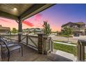 Inviting covered porch with seating, offering scenic neighborhood views and a relaxed ambiance at 10991 Xanadu St, Commerce City, CO 80022