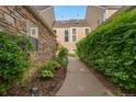Landscaped walkway between townhomes with stone and siding exterior, showing meticulous property grounds at 10000 E Yale Ave # 41, Denver, CO 80231