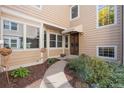 Welcoming front entrance with decorative door, awning, and lush landscaping at 10000 E Yale Ave # 41, Denver, CO 80231
