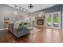 Inviting living room with a stone fireplace, hardwood floors, and plenty of natural light at 10000 E Yale Ave # 41, Denver, CO 80231