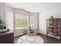 Bright living room showcasing hardwood floors, large windows offering natural light, cozy seating, and elegant decor at 18477 E Amherst Dr, Aurora, CO 80013