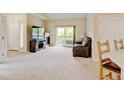Cozy living room with a fireplace, TV, comfy sofa and sliding glass doors that lead to the balcony at 8726 S Kline St # A204, Littleton, CO 80127
