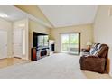 Inviting living room featuring a fireplace, media console, and sliding glass doors to the balcony for natural light at 8726 S Kline St # A204, Littleton, CO 80127
