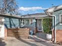 Brick patio with wooden privacy wall, seating, and potted plants at 1750 Vance St, Lakewood, CO 80214