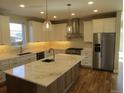 Spacious kitchen with large island, granite countertops, stainless steel appliances, and custom cabinetry at 1970 S Logan St, Denver, CO 80210