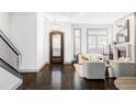 Bright entryway with hardwood floors, modern staircase, and fireplace at 105 Fillmore St # 204, Denver, CO 80206