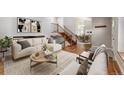 Bright living room showcasing modern decor, stylish furniture, and an open floor plan at 13849 W 66Th Dr, Arvada, CO 80004