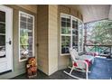 Comfortable front porch with view and wicker seating, offering a relaxing outdoor space with neighborhood view at 10343 Stoneflower Dr, Parker, CO 80134