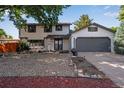 Beautiful two-story home with a two-car garage and a well-maintained, low maintenance front yard at 10851 E Iliff Pl, Aurora, CO 80014