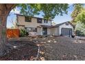 Charming two-story home with an attached two-car garage and a nicely landscaped front yard at 10851 E Iliff Pl, Aurora, CO 80014