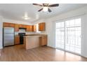Open-concept kitchen features modern appliances, ample cabinetry, and access to the outdoor patio at 3577 S Ouray Cir, Aurora, CO 80013