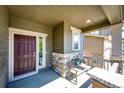 Inviting front porch with stone accents and a cozy bench, perfect for relaxing at 947 W Beverly St, Elizabeth, CO 80107