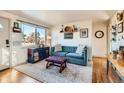 Inviting living room with a comfortable blue sofa and bright natural light at 4332 Bruce Randolph Ave, Denver, CO 80207
