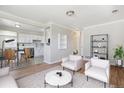Open-concept living room with hardwood floors and white walls at 2340 Geneva, Aurora, CO 80010