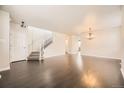 Spacious living room with hardwood floors, staircase, and ample natural light at 10037 Idalia St, Commerce City, CO 80022