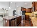 Lovely kitchen featuring an island with a stainless steel dishwasher, stainless steel appliances, and wood flooring at 21646 E Stroll Ave, Parker, CO 80138