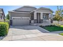 Charming home featuring a well-manicured lawn, covered porch, and attached two car garage at 10546 Boston St, Commerce City, CO 80640