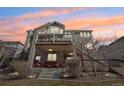 Spacious backyard featuring a multi-level deck and patio perfect for entertaining or relaxing under a colorful sunset sky at 8131 S Coolidge Way, Aurora, CO 80016