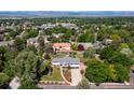 Aerial view of a neighborhood featuring a ranch-style home with a well-kept yard and mature trees at 2125 Rangeview Ln, Longmont, CO 80501