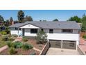 Charming ranch-style home with a landscaped front yard, and a two-car garage at 2125 Rangeview Ln, Longmont, CO 80501