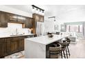 Bright kitchen features an island with bar seating and a view of the living area at 1551 Larimer St # 1405, Denver, CO 80202